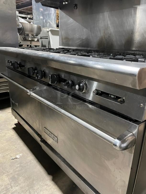 American Range stainless steel natural gas 10-burner range with double oven, backsplash, overhead salamander shelf, and casters.