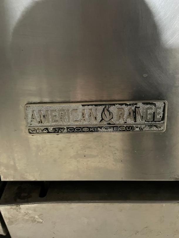 American Range stainless steel 10-burner range with double oven, backsplash, overhead salamander shelf, and casters.