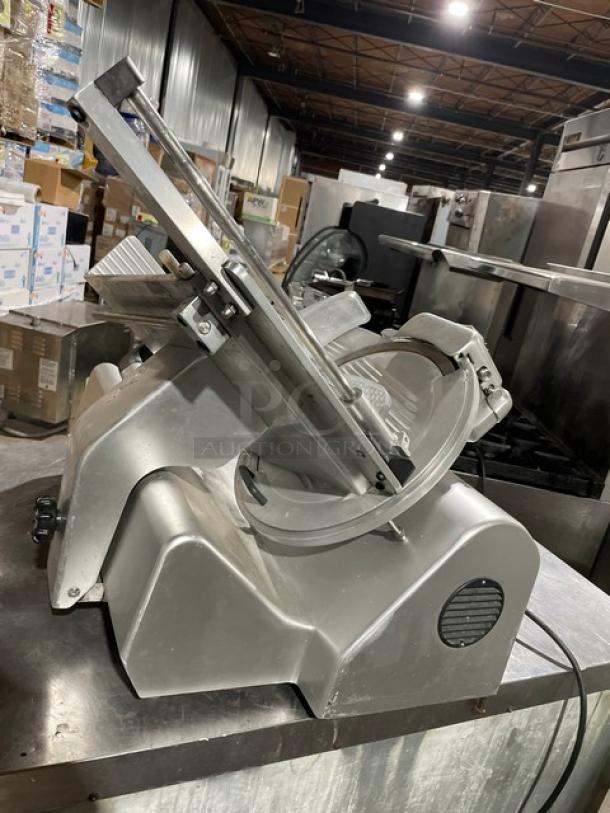 Kolossal 330IKUS electric deli meat slicer on legs, 120V, with adjustable blade and safety features, in good condition.