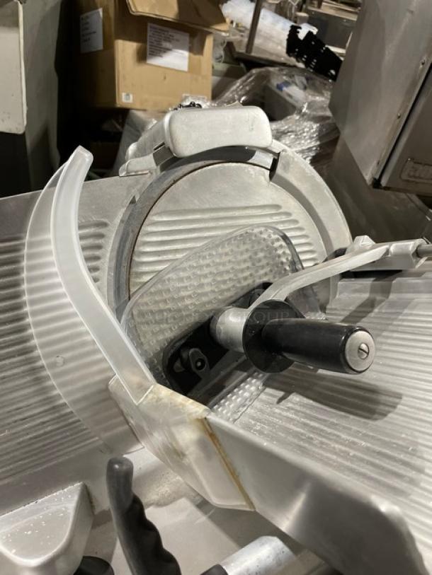 Kolossal 330IKUS commercial electric deli meat slicer, used condition, on legs, 120V, serial number 1590/08, countertop model.