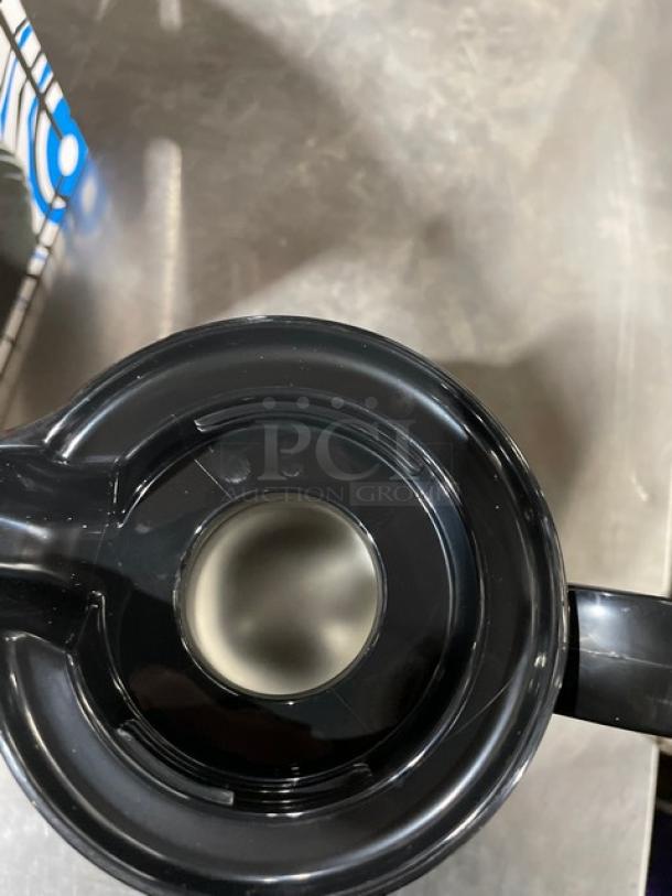 Adcraft SP40BK insulated black 40 oz. beverage server, new condition, top view showing lid and handle.