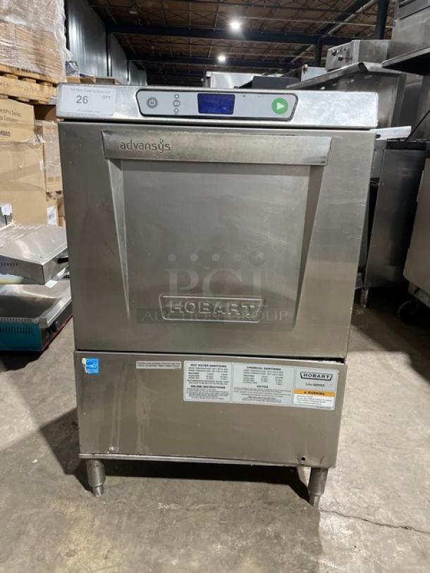 Hobart LXe Series stainless steel undercounter dishwasher, energy-efficient, on legs, visible control panel and labels.