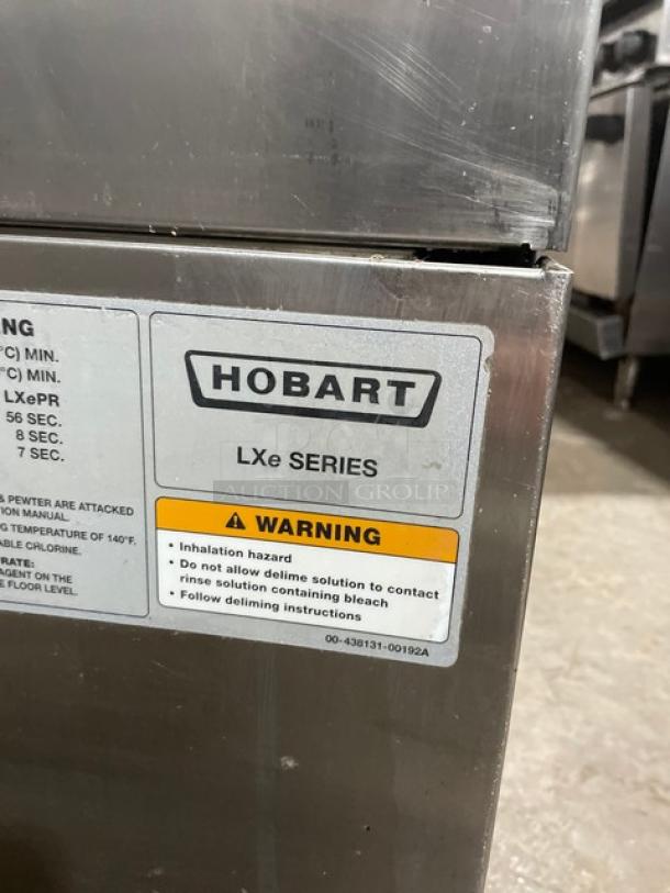 Hobart LXe Series stainless steel undercounter dishwasher, Energy Star certified, new body style, on legs, with warning label.