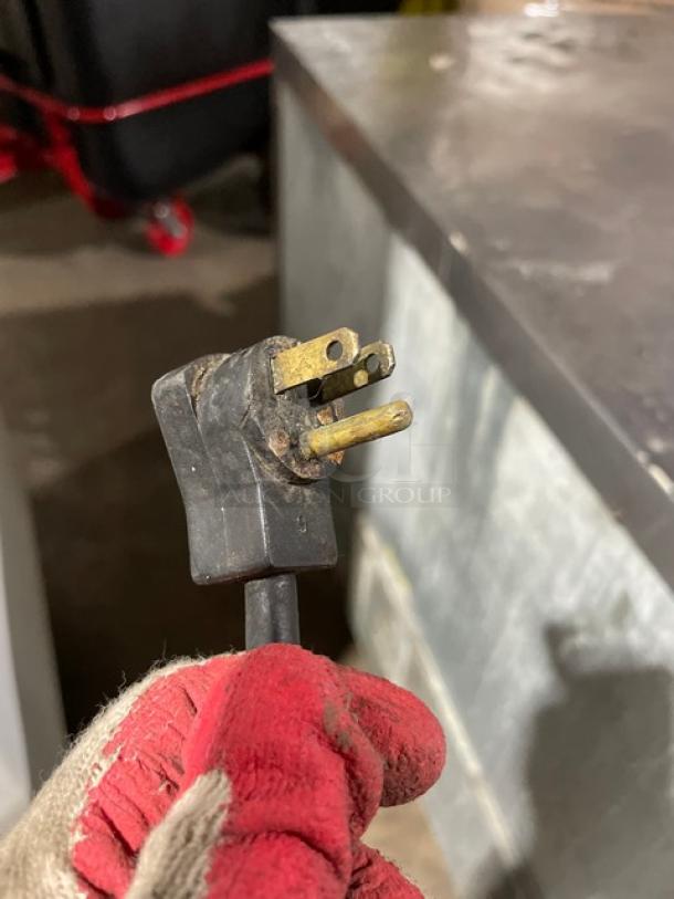 Close-up of a power plug for the Beverage-Air WTR48A refrigerator, indicating 115V for commercial use.