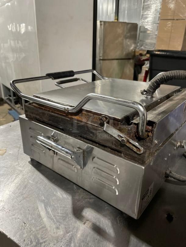 Waring Panini Supremo WPG250T grill with stainless steel finish, grooved grates, and timer. Good condition, 120V.