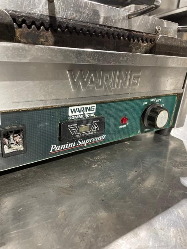 Waring Panini Supremo grill, model WPG250T, stainless steel, electric, with timer, grooved grates, visible controls.