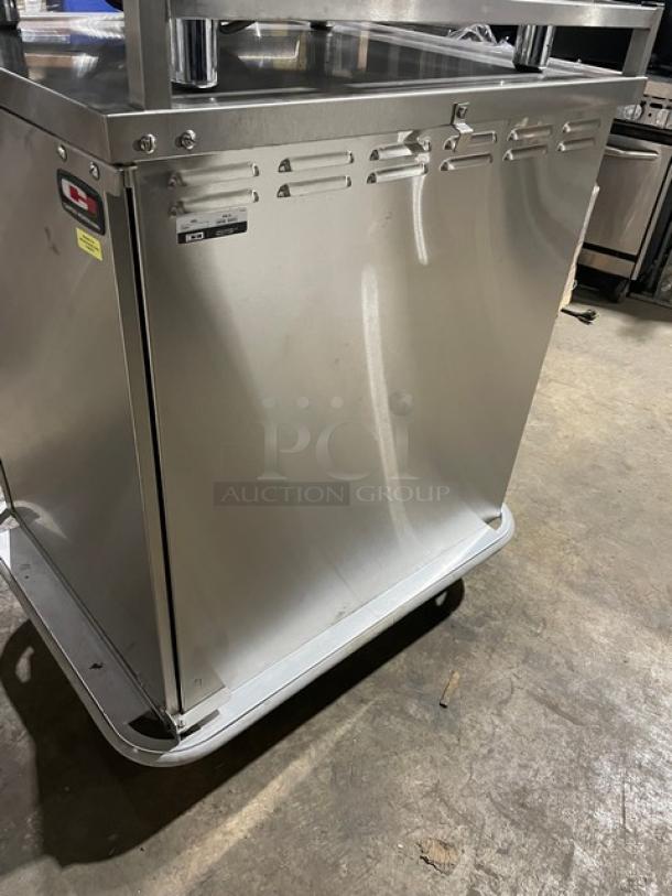 Carter-Hoffmann stainless steel meal/tray cart, model TE1S12, with solid single door, built-in pan slide, and casters.