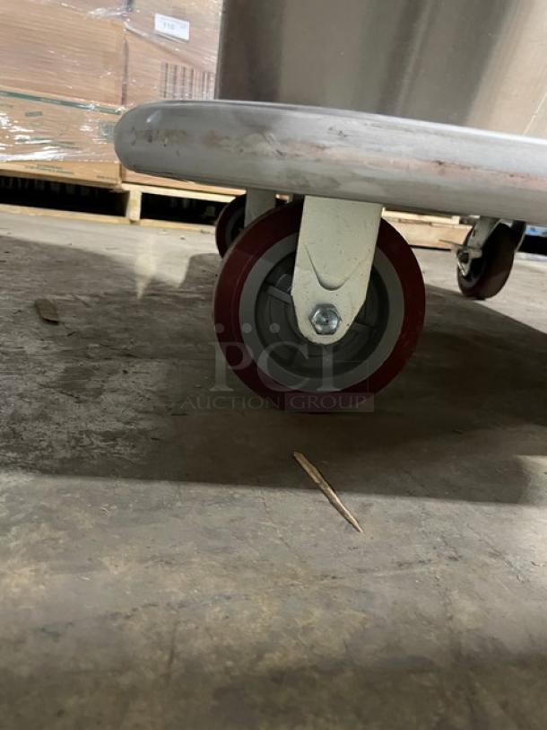 Carter-Hoffmann stainless steel transport cart model TE1S12, with built-in pan slide and casters, showing a wheel detail.