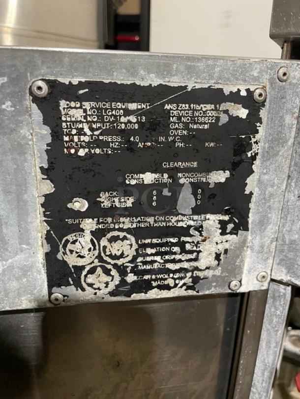 Vulcan LG400 commercial stainless steel deep fat fryer with back splash, natural gas powered, model SN DV1048513, on legs.