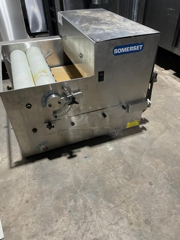 Somerset commercial stainless steel electric dough moulder, featuring control dials and rollers. Compact design, excellent condition.