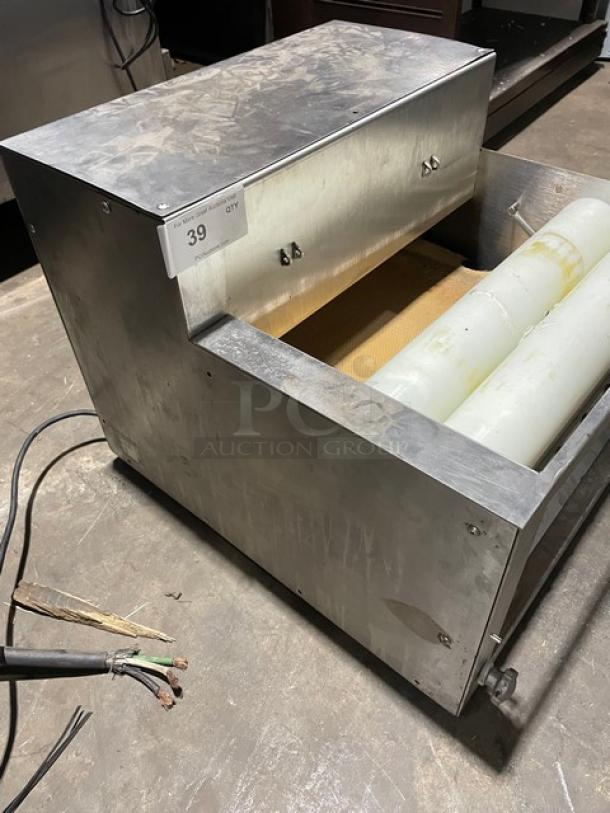 Somerset commercial stainless steel dough moulder, electric-powered, compact design. Visible wear, assorted cables attached.