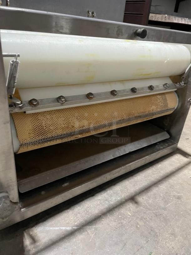 Somerset commercial stainless steel electric dough moulder, compact size, features visible rollers and metal structure.