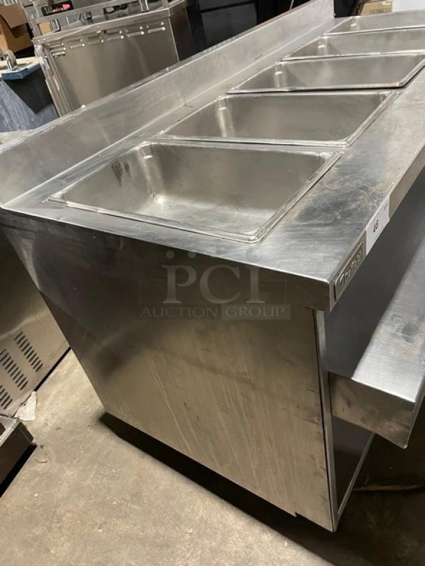 Delfield stainless steel gas-powered 5-well steam table with lower tray slide, undershelf, and up-turned backsplash.
