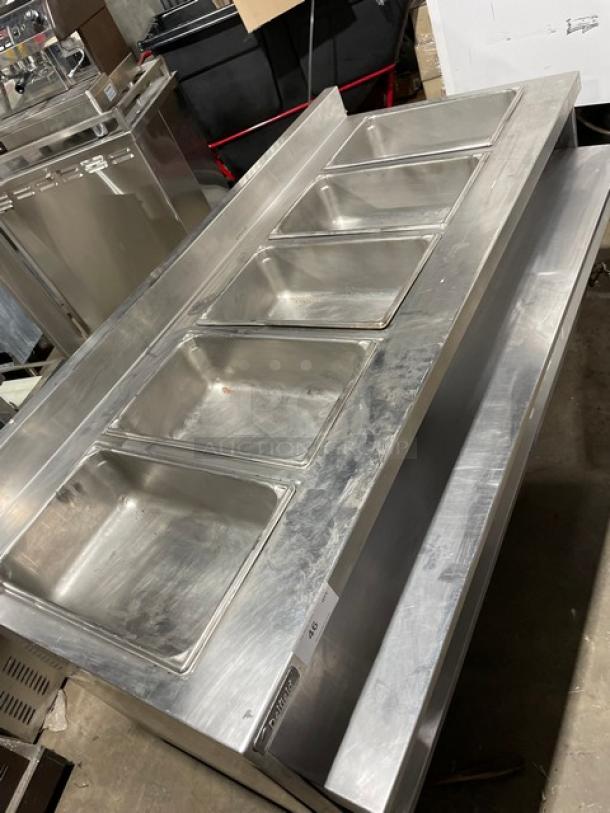 Delfield stainless steel gas-powered 5-well steam table with tray slide, undershelf, and upturned backsplash, in good condition.
