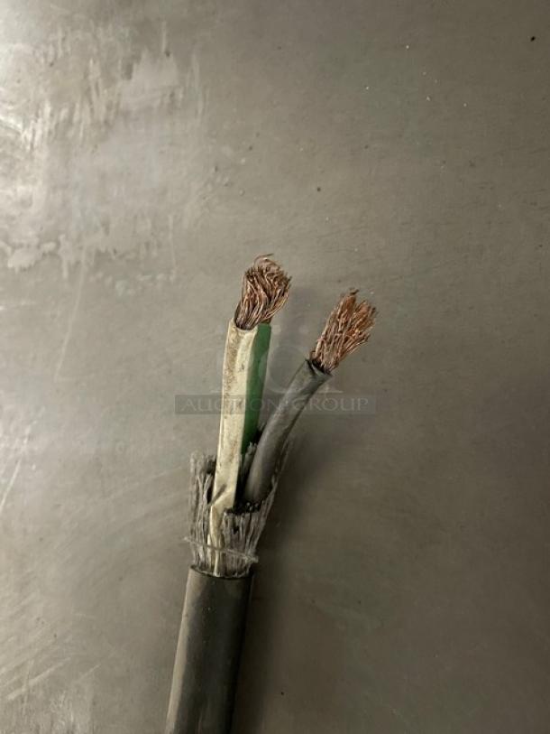 Frayed electrical wires on a gray surface. Item is not fully visible. Condition appears to show exposed wires.