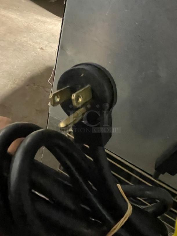 Imbera VFS24-R2 commercial freezer power cord. 115V, 1-phase plug detail. Black cable, ready for connection.