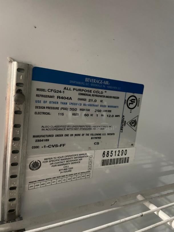 Beverage-Air CFG24-1 reach-in merchandiser freezer, glass door, poly wired rack, model label showing specs and SN: 6851290.