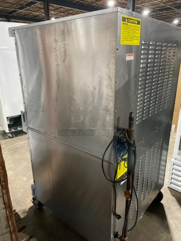 Vulcan SG4D1 stainless steel double-stacked convection oven, natural gas, on casters, includes wired oven rack, visible caution label.