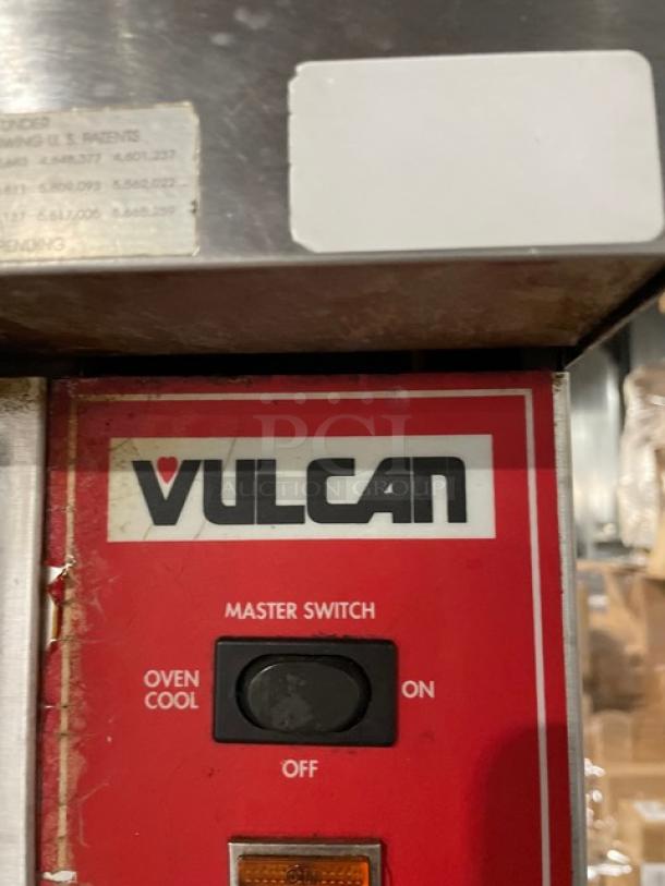 Vulcan SG4D1 stainless steel convection oven, natural gas powered, with wired rack. Features master switch and caster base.