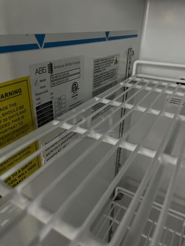 ABS Commercial Refrigerator, Model PHABTHCS16GDJA, white, glass door, poly coated rack, serial ABS-20153113-2109, on casters.