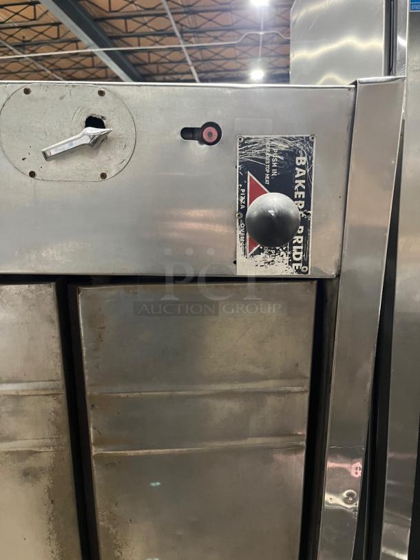 Bakers Pride stainless steel double stacked pizza deck oven, natural gas powered, visible wear, branded label shown.