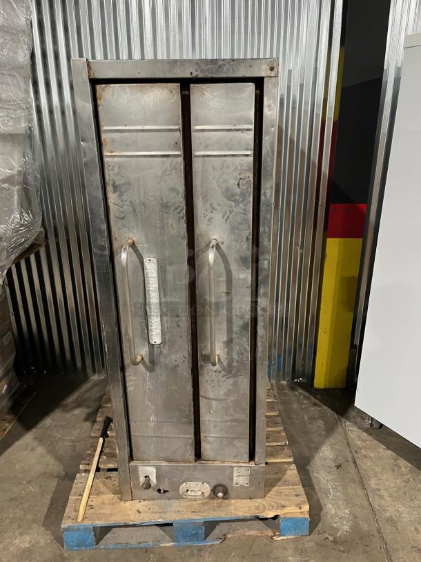 Bakers Pride stainless steel double stacked pizza deck oven, natural gas powered, used, visible signs of wear, industrial setting.