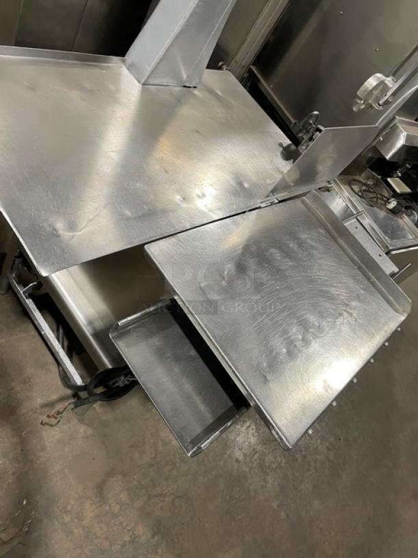Butcher Boy commercial stainless steel meat band saw on legs. Heavy-duty, electric-powered, free-standing design in good condition.