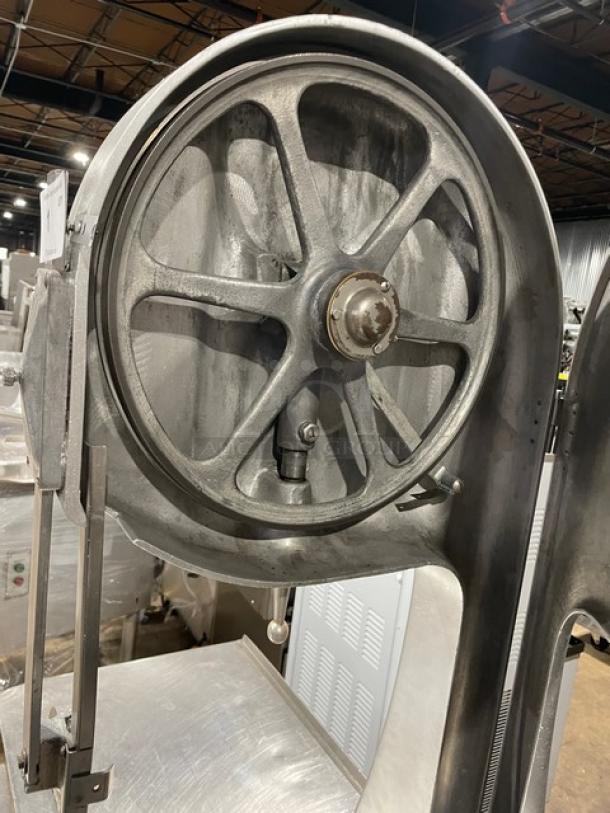 Butcher Boy stainless steel electric meat band saw, free-standing, heavy-duty, visible wheel and support leg, used condition.