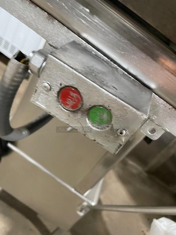 Butcher Boy stainless steel electric meat band saw, featuring control buttons, industrial setting, moderate wear.