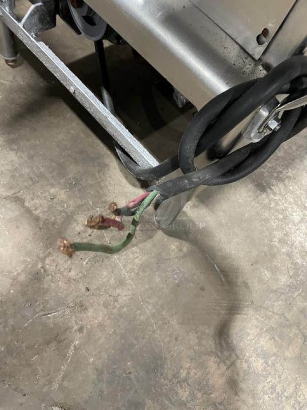 Butcher Boy stainless steel electric meat band saw, free-standing, heavy-duty, on legs; power cords visible, needs wiring.