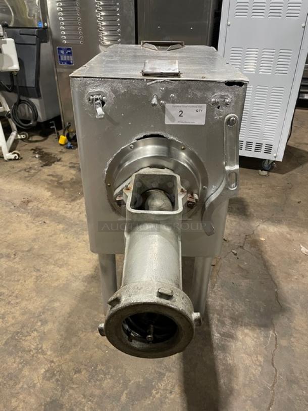 Hobart commercial heavy-duty meat grinder, electric-powered, free-standing on legs. Visible wear, includes feeding chute. Model number not shown.