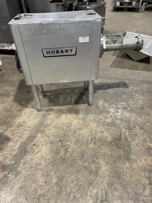 Hobart commercial electric meat grinder, free-standing, heavy duty, on legs. Visible Hobart label, industrial use. Good condition.