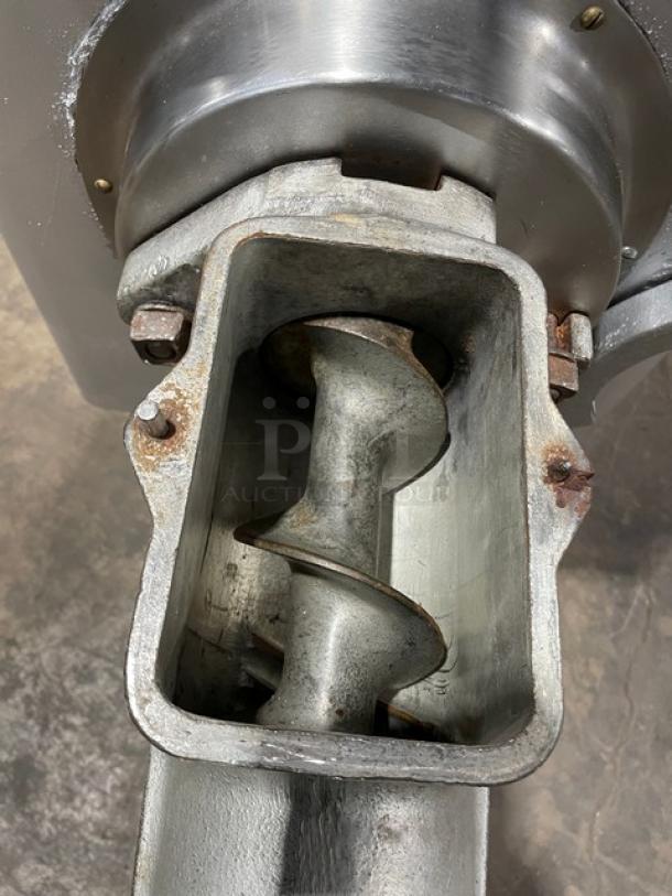 Hobart commercial heavy-duty meat grinder, electric-powered, free-standing on legs. Visible auger and grinder mechanism, used condition.