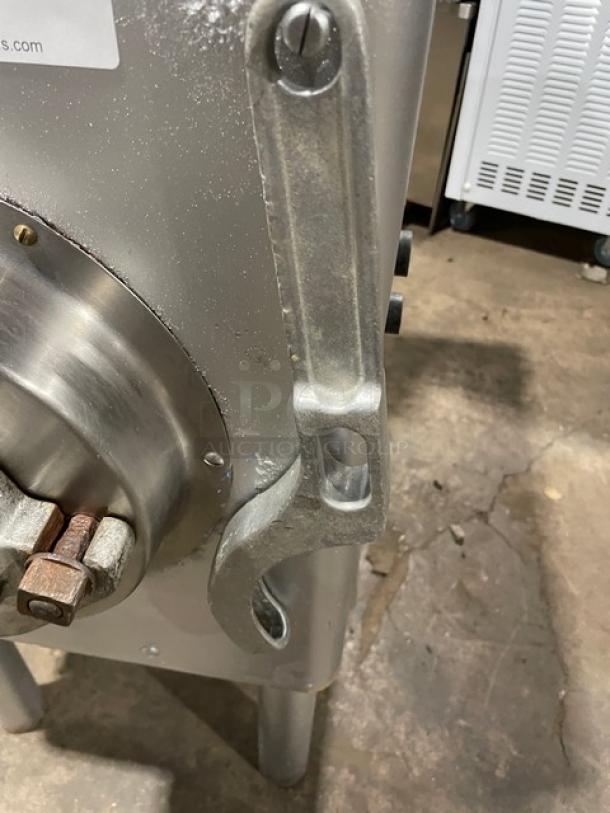 Hobart commercial electric meat grinder, free-standing with legs, heavy-duty steel construction, visible bolts and levers.