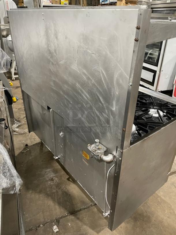 Vulcan commercial stainless steel 10-burner range and double oven with backsplash, overhead salamander shelf, and wired rack.