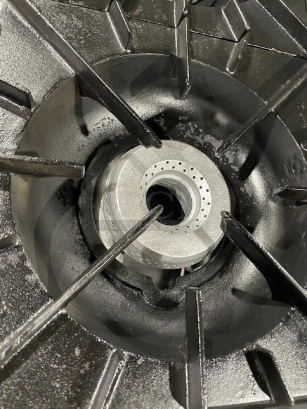 Close-up of Vulcan commercial range burner, showing clean, intricate burner design and sturdy cast iron supports.