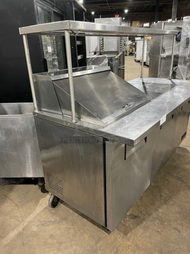 True TSSU-72-12M-B commercial stainless steel 3-door prep table with overhead shelf, wired rack, on casters, 115V, 1 phase.
