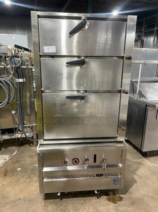 Commercial stainless steel 3-compartment seafood steamer, natural gas powered, with individual controls, wired oven rack, on legs.