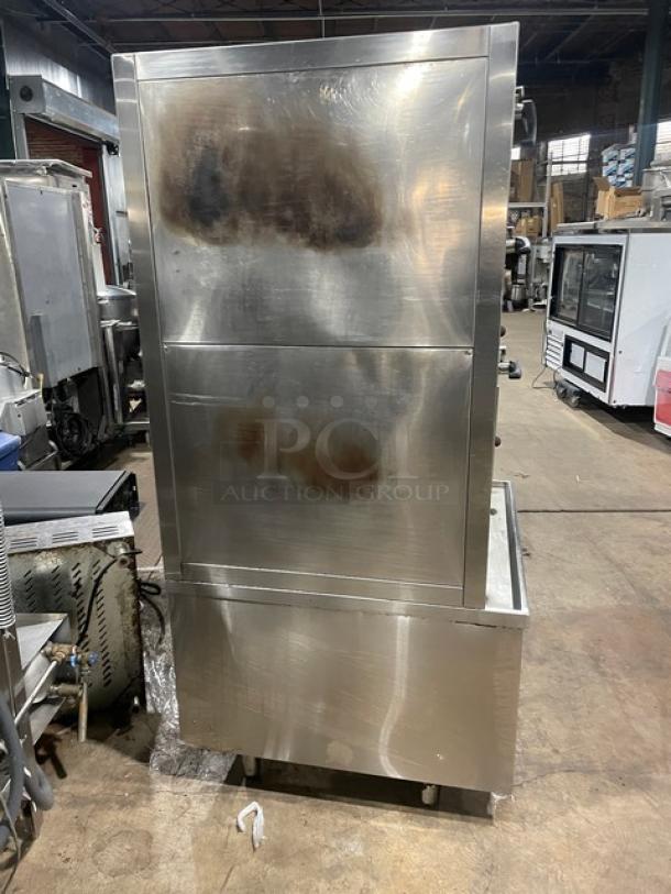 Commercial stainless steel 3-compartment seafood steamer with individual controls, wired oven rack, on legs, natural gas powered.