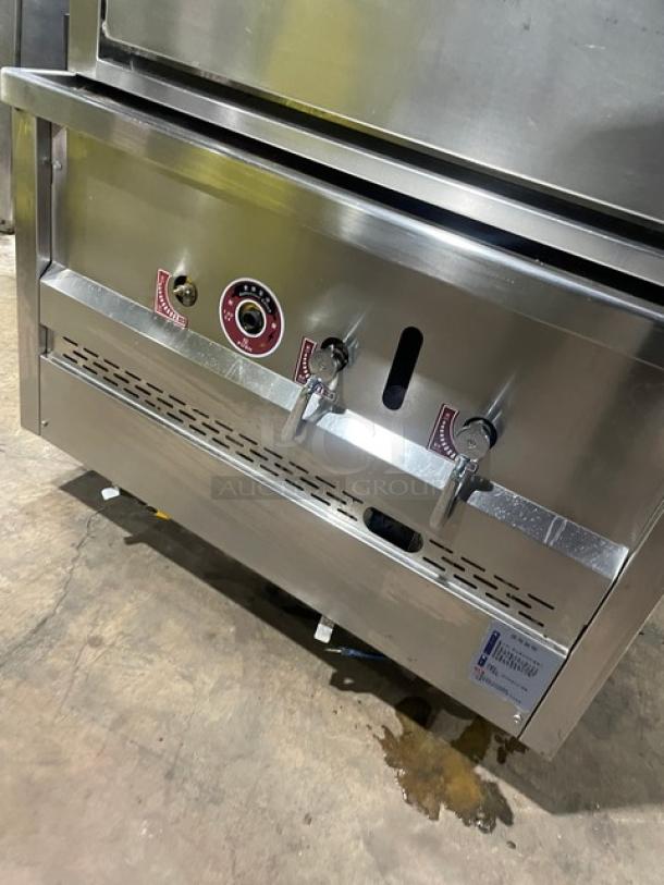 Commercial stainless steel 3-compartment seafood steamer with individual controls, wired oven rack, and legs. Natural gas powered.