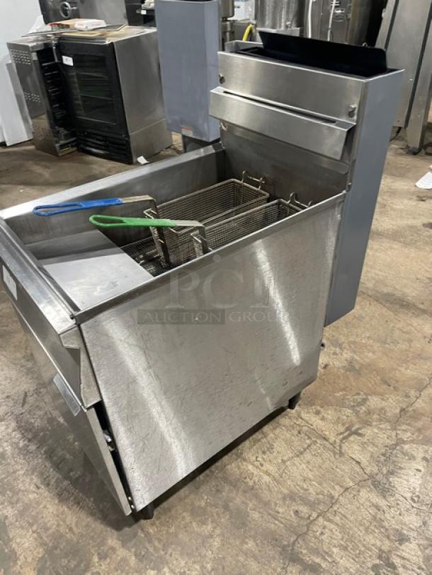 Commercial stainless steel natural gas deep fat fryer with backsplash, basket hanger, fry basket, on legs.