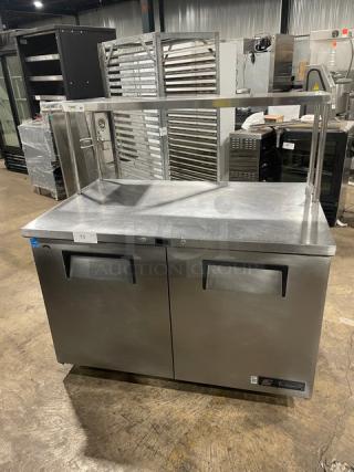 True TUC-48 stainless steel 2-door worktop refrigerator, Energy Star certified, with overhead shelf and poly-coated wire rack.