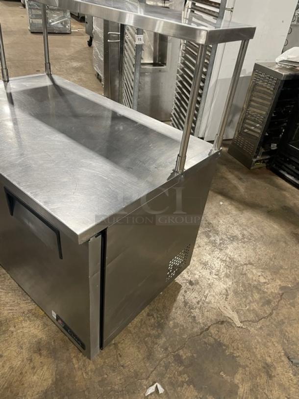 True TUC-48 stainless steel worktop refrigerator, 2-door, Energy Star certified, with overhead shelf and poly-coated rack, on casters.