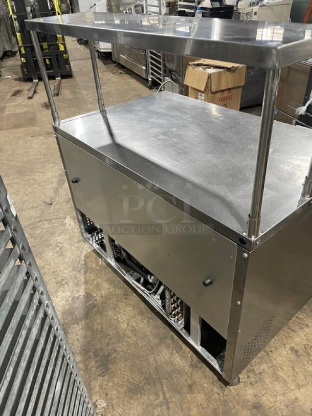 True TUC-48 stainless steel 2-door worktop refrigerator with overhead shelf, Energy Star certified, poly coated rack, on casters.