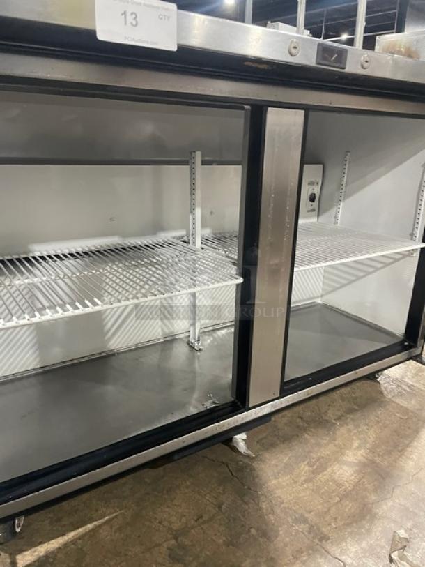 True TUC-48 stainless steel 2-door worktop refrigerator with overhead shelf, poly-coated racks, Energy Star certified, on casters.