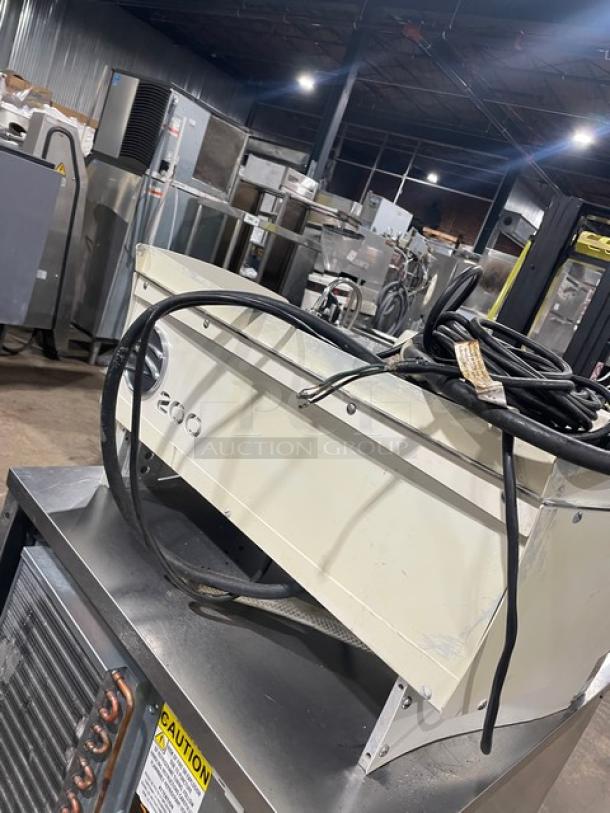 Synesso S200 Series white two-group espresso machine, electric powered, with steam wand. In good condition with visible wiring on top.