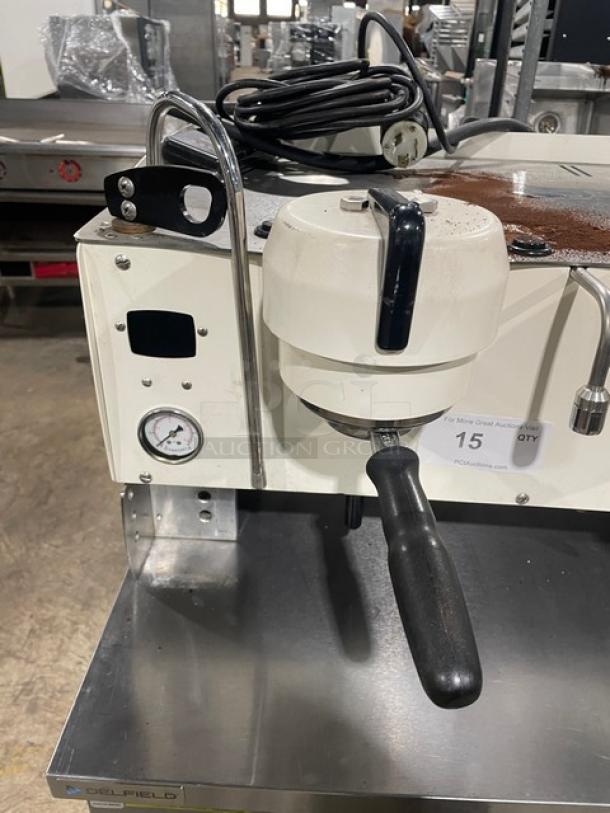 Synesso S200 Series white commercial espresso machine with two-group setup and steam wand; shows control panel and pressure gauge.