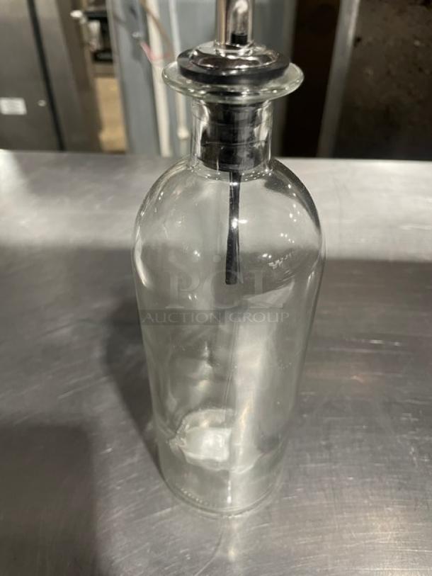 Clear glass 18 oz. oil & vinegar cruet bottle by TableCraft, Model 10375, with stainless steel pourer, new condition.