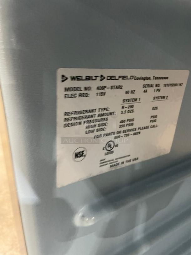 Delfield 406P-STAR2 commercial stainless steel undercounter refrigerator, 115V, single door, on casters, model label visible.