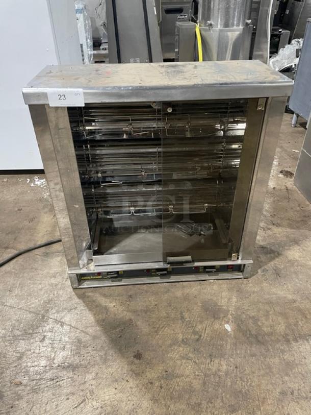 Robot Coupe stainless steel electric countertop rotisserie cabinet with visible control panel and legs, commercial use.